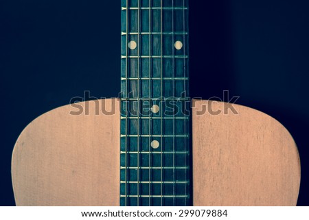 Closeup front view of wooden acoustic guitar