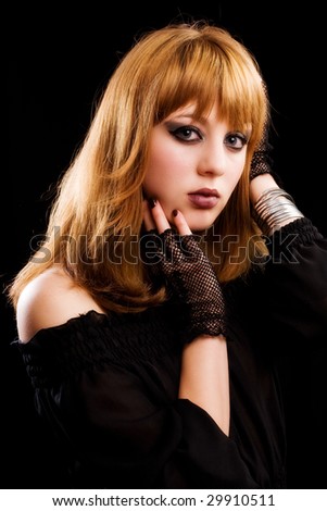 Portrait of a gothic young lady isolated on dark background