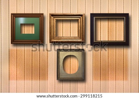 Gilded wooden frames for pictures on striped background 