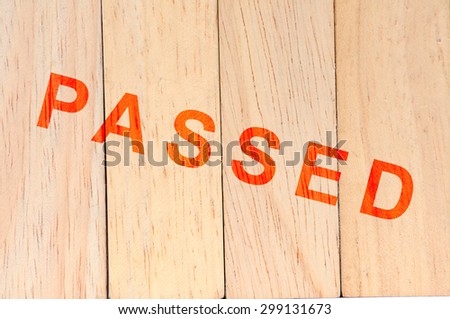 Light brown wood background with passed stamp.