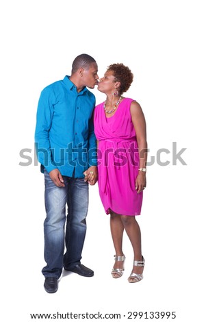 Full length photo of a pregnant couple kissing isolated on white