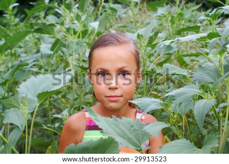 Smiling preteen girl in green grass