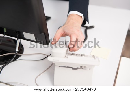 Businessman Pick Up Or Hangs Up The Phone In The Office