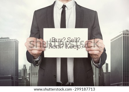 Buy vs sell vs rent vs keep on paper what businessman is holding on cityscape background