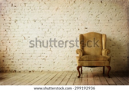 Old Retro Armchair against White Brick Wall Interior Royalty-Free Stock Photo #299192936