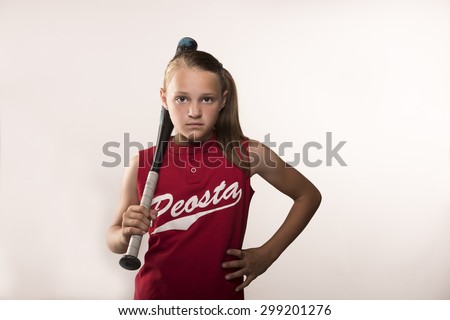 Softball girl with bat on shoulder