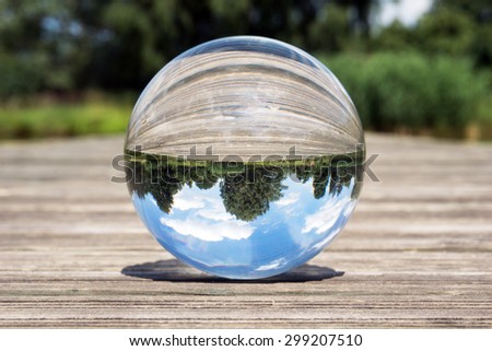 Glass sphere picture in nature with blue sky / Glass ball