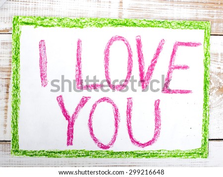 words  I LOVE YOU written in crayon on paper