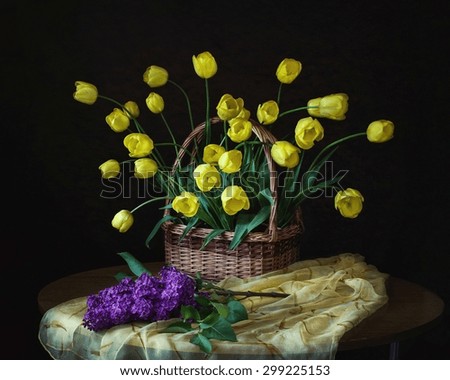 With yellow tulips and lilac branch