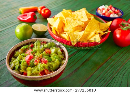Mexican food nachos guacamole pico de gallo and chili peppers sauces