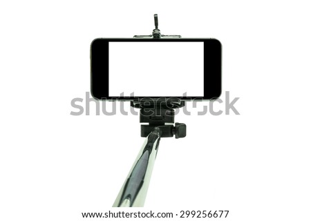 Smart phone on a selfie stick shot in studio Royalty-Free Stock Photo #299256677