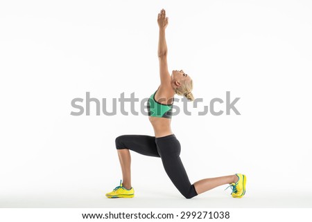 Rhythmic gymnast doing exercise in studio.