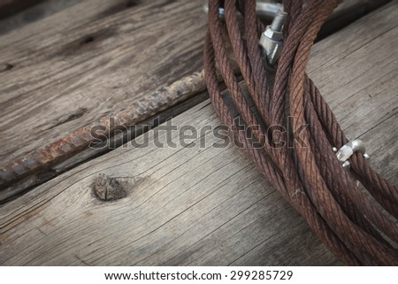 Abstract Rusty Aged Iron Cable Laying on Old Wood Planks.