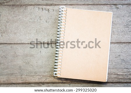 brown notebook on wooden texture
