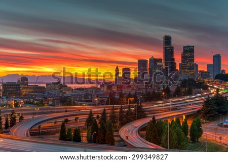 This is an epic sunset over Seattle skylines/downtown in summertime. The view is from Rizal Bridge, a prominent viewpoint for gorgeous sunset in Seattle. Cityscape, busy, rush hour, high speed concept