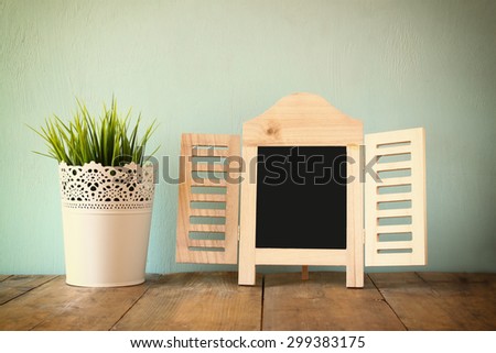 image of vintage wooden classical frame on wooden table. filtered image

