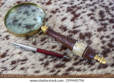 Magnifying Glass And  Pen On Leather Folder