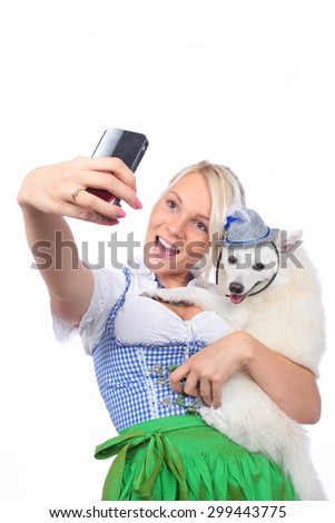 Bavarian woman taking picture in traditional costume isolated