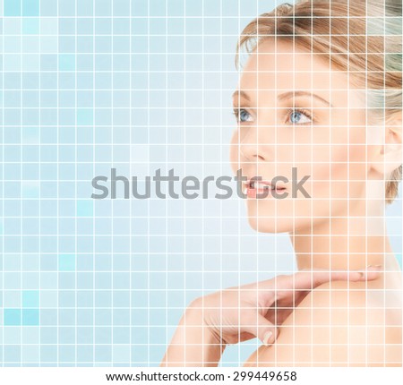 beauty, people and health concept - beautiful young woman touching her bare shoulder over blue background with squared grid
