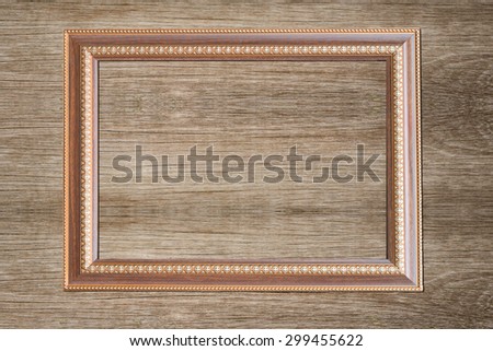 Grunge gold wooden frame on the wooden wall