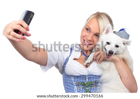 Bavarian woman taking picture in traditional costume isolated