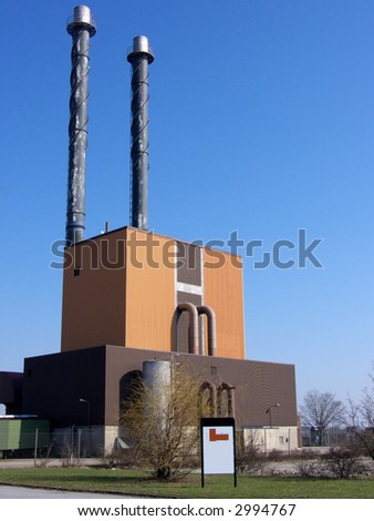 portrait of power plant with white sign infront for advertisement etc.