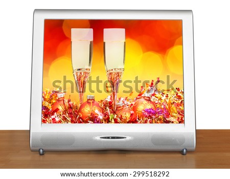 Christmas still life with orange balls and glasses on screen of TV set isolated on white background