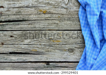 Blue towel over wooden kitchen table. View from above with copy space