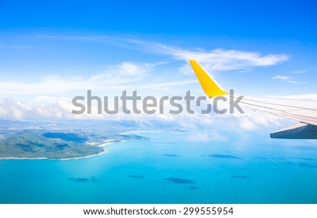 Wing of an airplane flying above the ocean. Photo applied to tourism operators. picture for add text message or frame website. Traveling concept