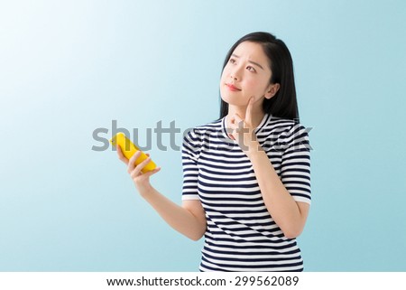 young attractive asian woman  to see a smart phone