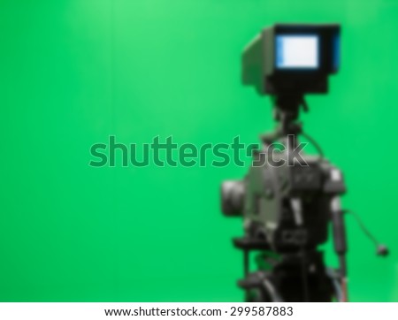 Blur image, TV camera in studio scene green screen.