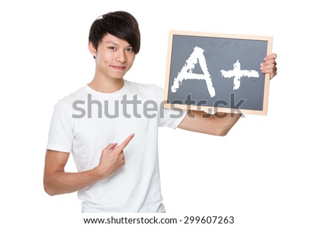Man hold with chalkboard showing A plus mark 