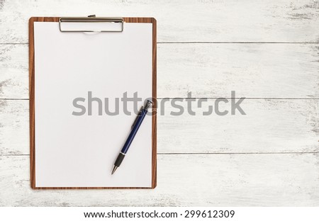 Blank paper on wooden clipboard with space on background Royalty-Free Stock Photo #299612309