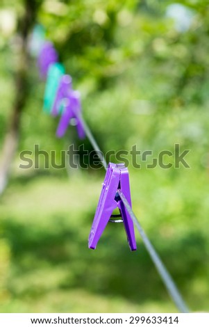 Clothes pegs on a wire. 