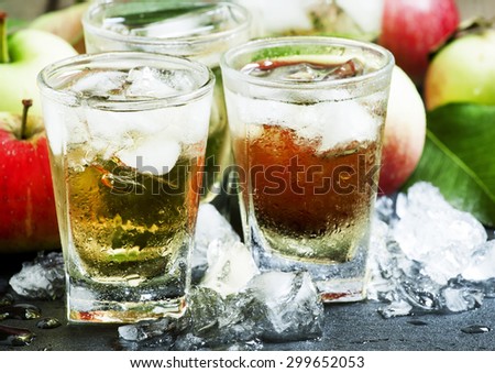 Cool refreshing apple juice with ice and fruit, selective focus