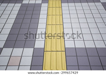 yellow color blind floor tiles on public walkway