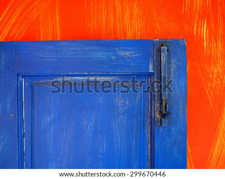 old vintage retro style colorful cute door and frame on artistic painted wall close up as backdrop or background 