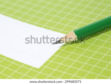 Back to school. An image of a pencil against a notebook.