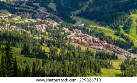 Sun Peaks Village nestled in Central British Columbia as seen from the Chairlift going up Tod mountain in Summer. Royalty-Free Stock Photo #299826710