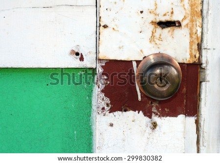 old wooden door, round doorknob, green and white paint