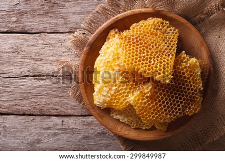 Golden honeycomb on a wooden plate on the table. horizontal view from above
 Royalty-Free Stock Photo #299849987