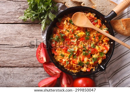 Menemen in a frying pan and ingredients on the table close-up. horizontal view from above
 Royalty-Free Stock Photo #299850047