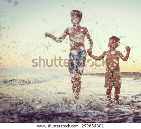 Fun kids playing splash at beach
