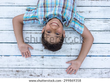 Child on white wooden background