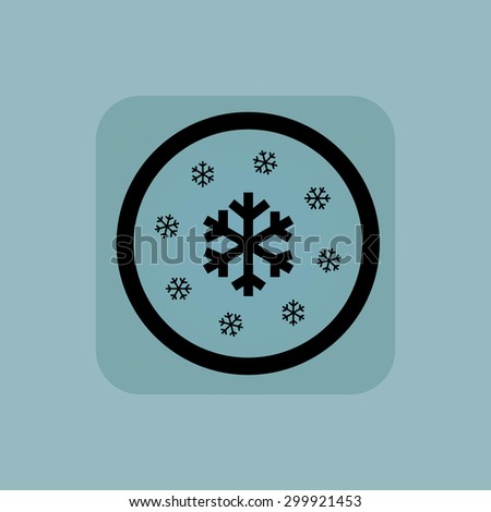 Several snowflakes in circle, in square, on pale blue background