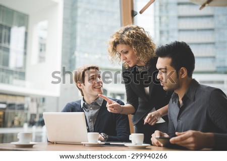 Multiracial contemporary business people working connected with technological devices like tablet and laptop, talking together - finance, business, technology concept Royalty-Free Stock Photo #299940266