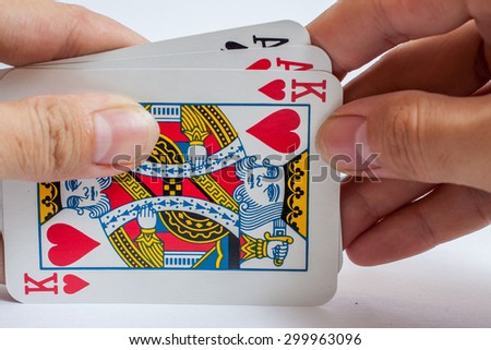 Hand with playing cards isolated on white background