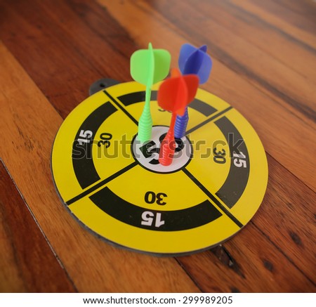 darts isolated on a wood background