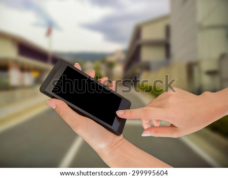 Businesswoman sending messages with her mobile phone, building Background