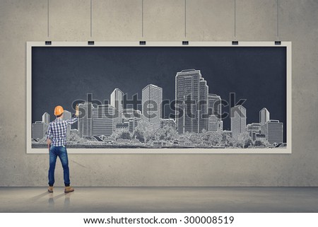 Rear view of businessman drawing business plan on banner